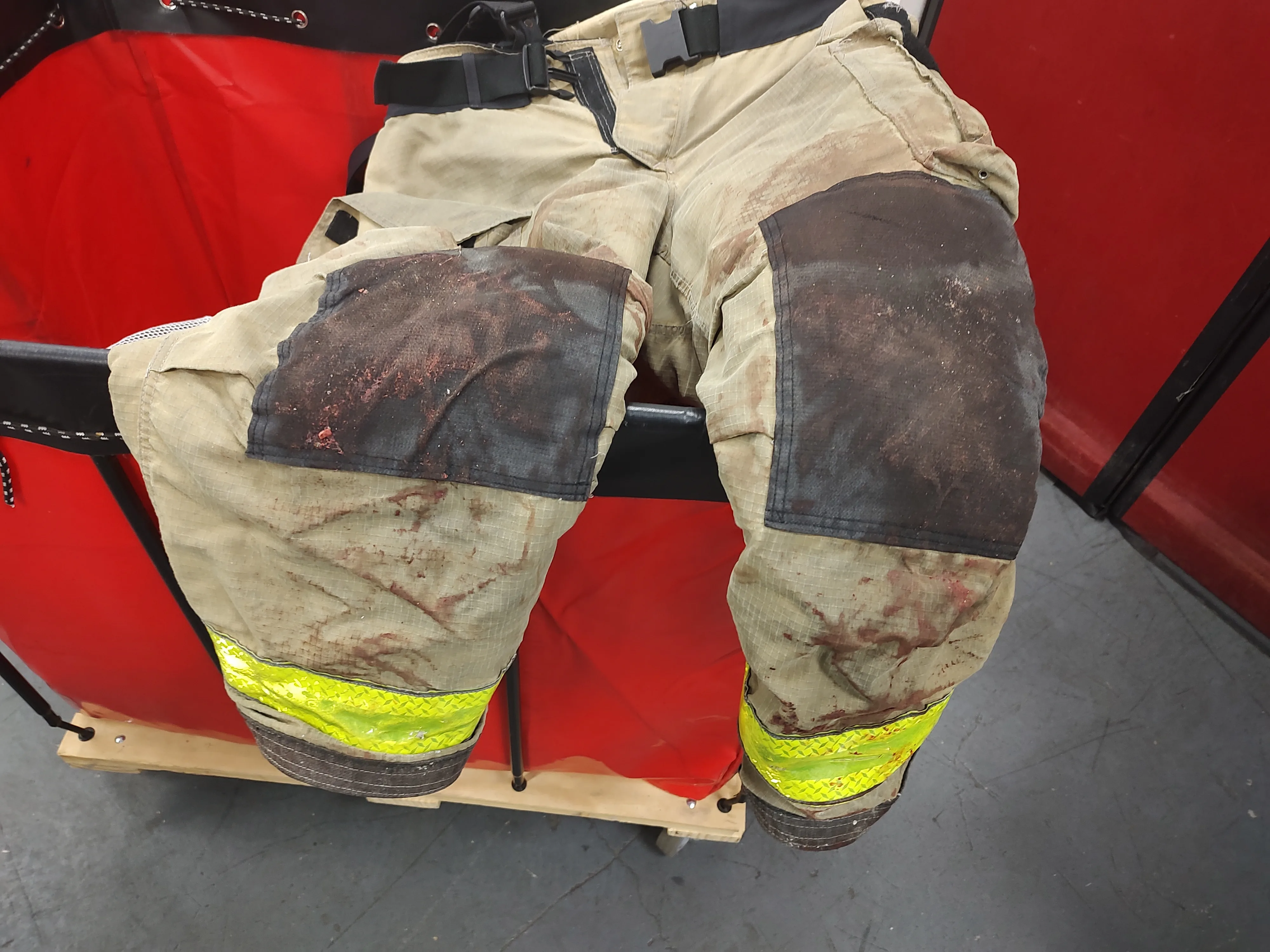 Heavily soiled turnout pants awaiting service