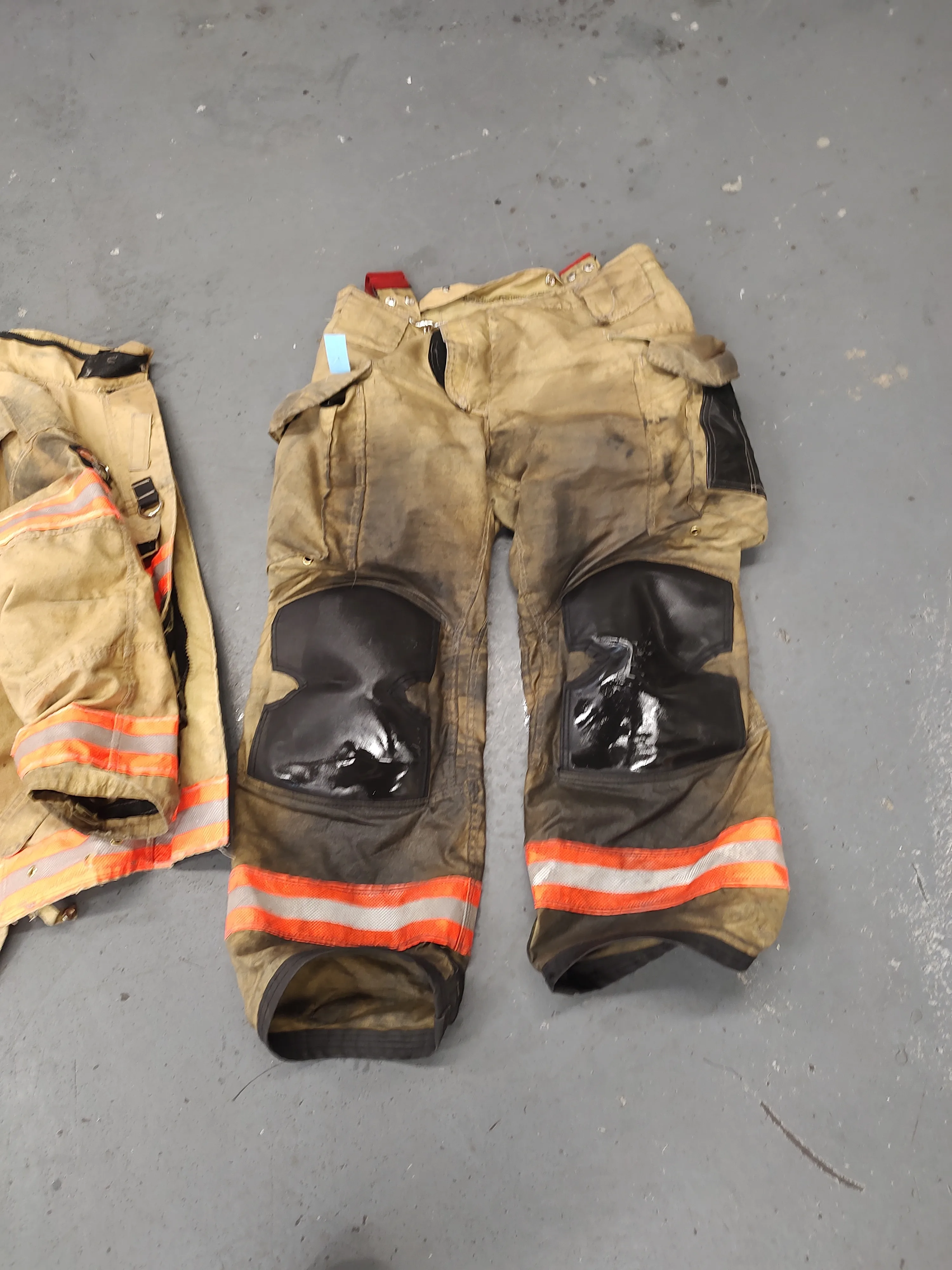 Turnout gear components laid out on the floor